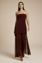 Model walking in burgundy dress